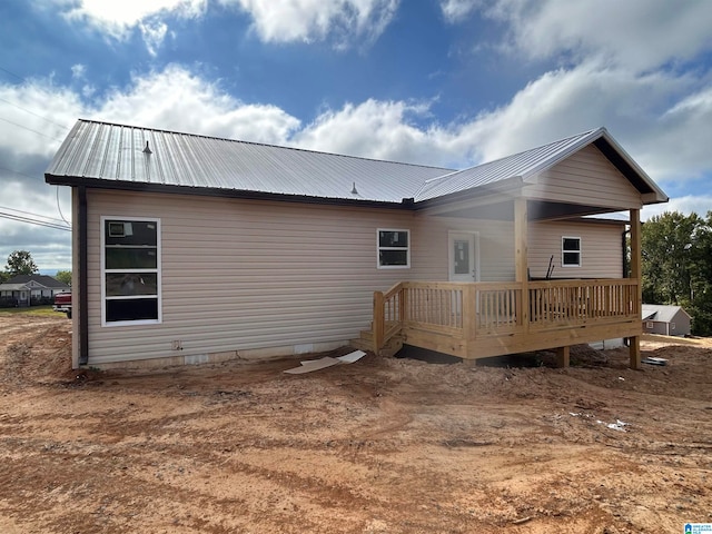 back of house with a wooden deck