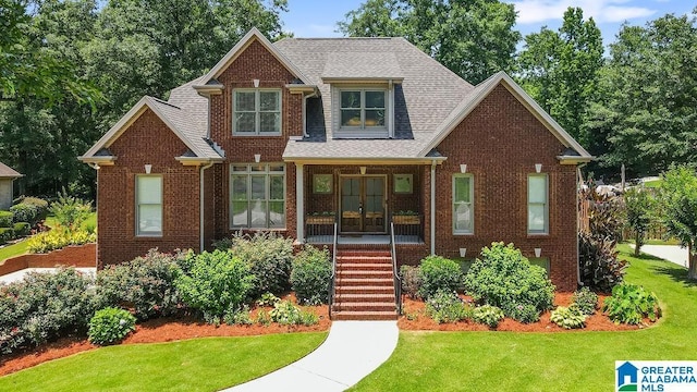 view of front facade with french doors and a front lawn