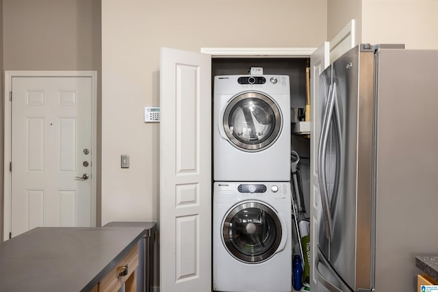 clothes washing area featuring stacked washer and dryer