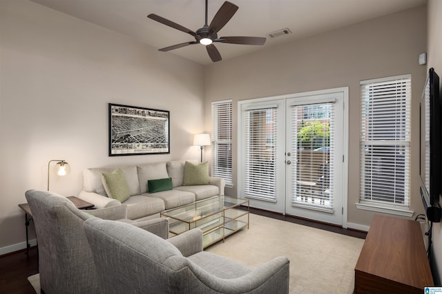 living room with ceiling fan, french doors, and dark wood-type flooring