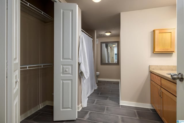 bathroom with tile flooring, vanity, and toilet