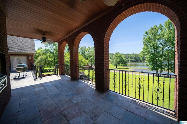 view of patio / terrace with a water view, a grill, and ceiling fan