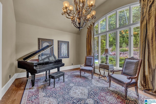 sitting room with hardwood / wood-style floors and a high ceiling