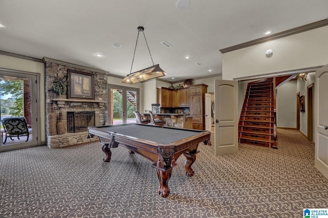 playroom with ornamental molding, light carpet, a fireplace, and french doors