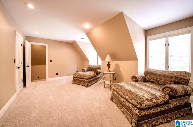 sitting room featuring vaulted ceiling and light colored carpet