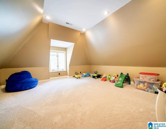 rec room with vaulted ceiling and carpet flooring