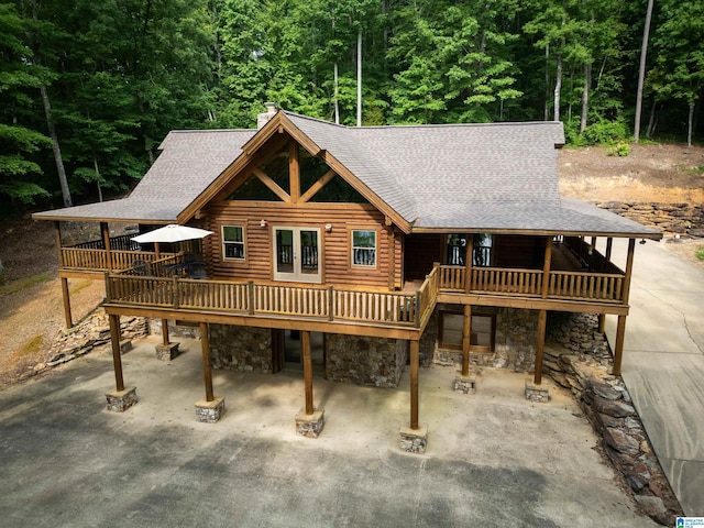 rear view of property featuring a deck and a patio area