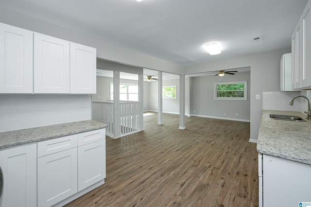 kitchen featuring dark hardwood / wood-style floors, white cabinetry, and sink