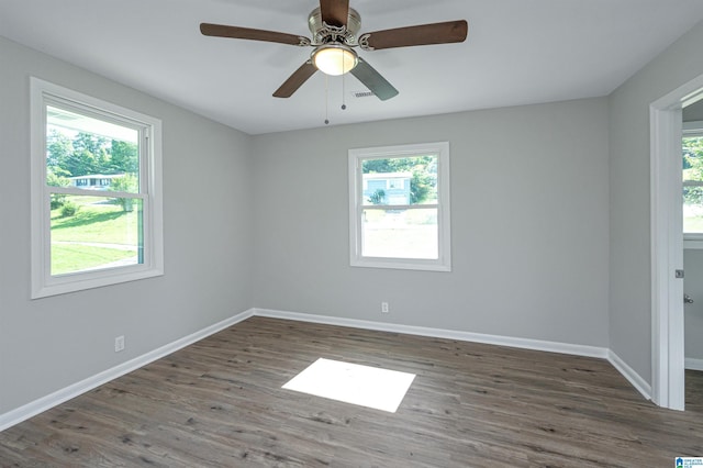 spare room featuring dark hardwood / wood-style flooring and ceiling fan