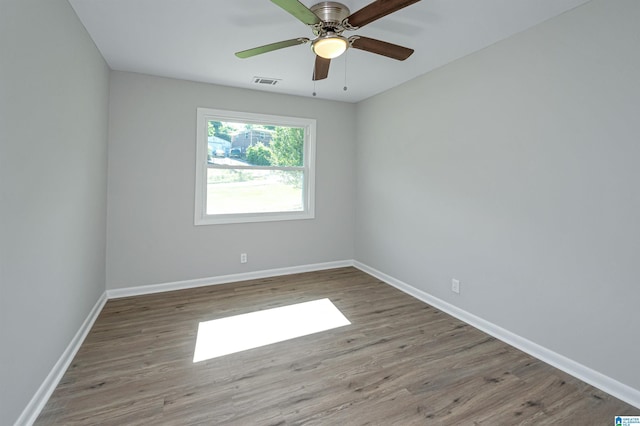 empty room featuring wood-type flooring and ceiling fan