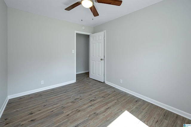 spare room featuring hardwood / wood-style flooring and ceiling fan