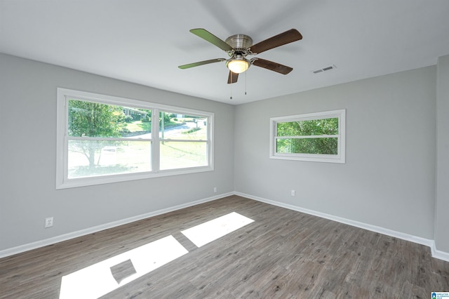 unfurnished room with ceiling fan and dark wood-type flooring