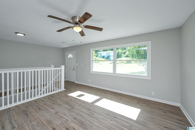 spare room with wood-type flooring and ceiling fan