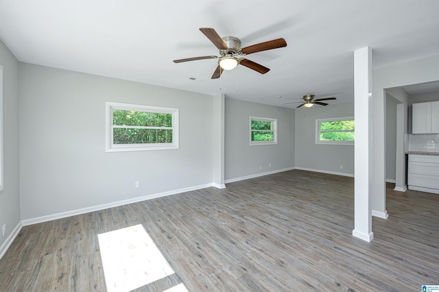 unfurnished living room featuring ceiling fan and light wood-type flooring