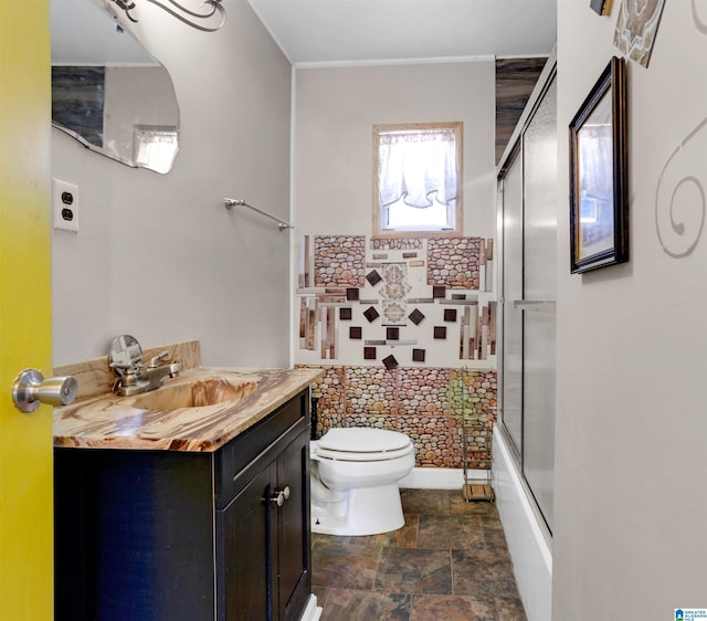 full bathroom with shower / bath combination with glass door, vanity, and toilet