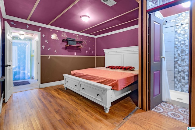 bedroom featuring hardwood / wood-style flooring and ornamental molding