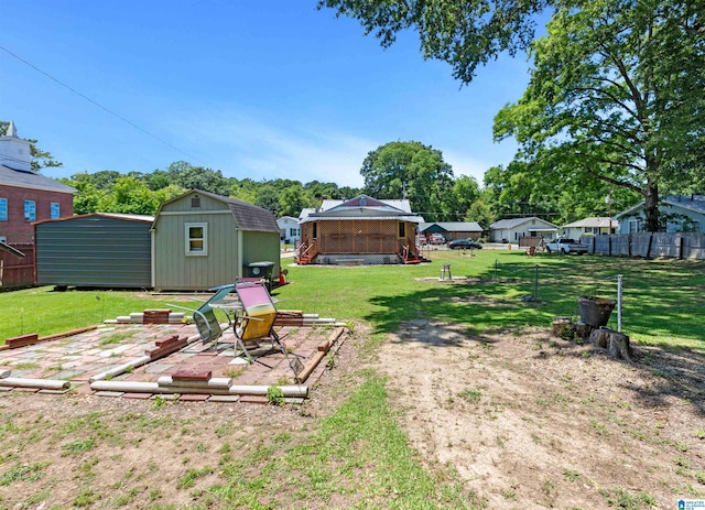 view of yard with a patio and a storage shed