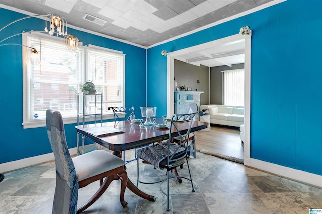 dining room featuring beam ceiling, ornamental molding, and coffered ceiling