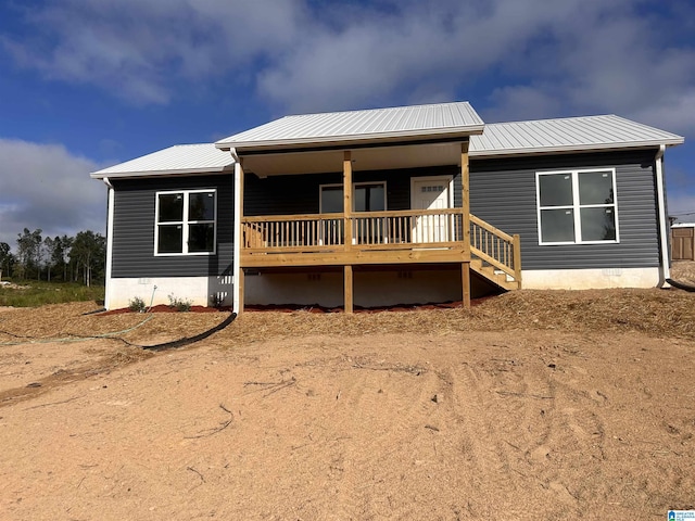 back of property featuring a porch