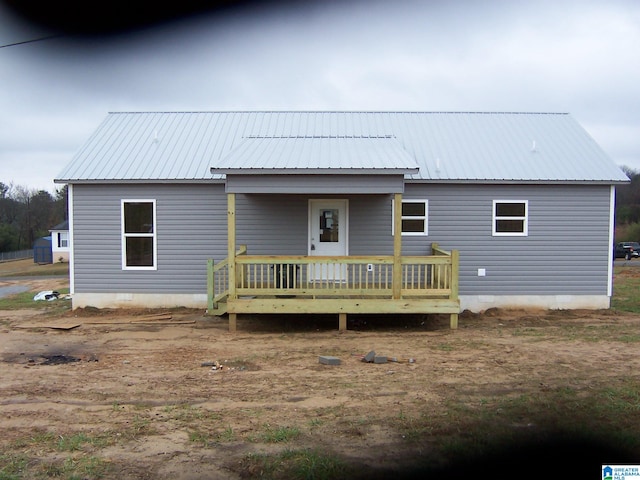 back of property with a wooden deck