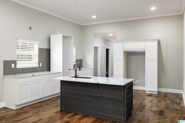 kitchen with a kitchen island, white cabinetry, sink, decorative backsplash, and dark wood-type flooring