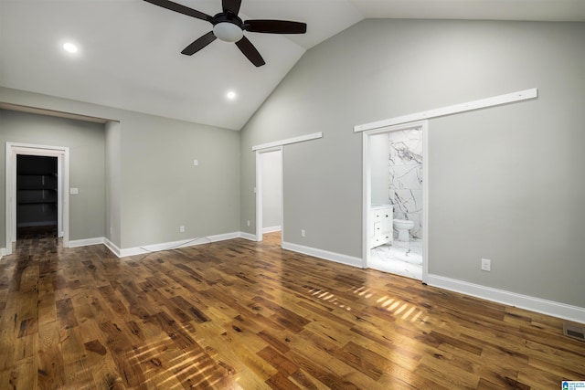 unfurnished living room with vaulted ceiling, dark hardwood / wood-style floors, and ceiling fan