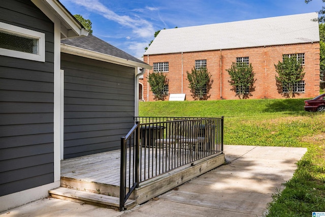 wooden terrace with a yard