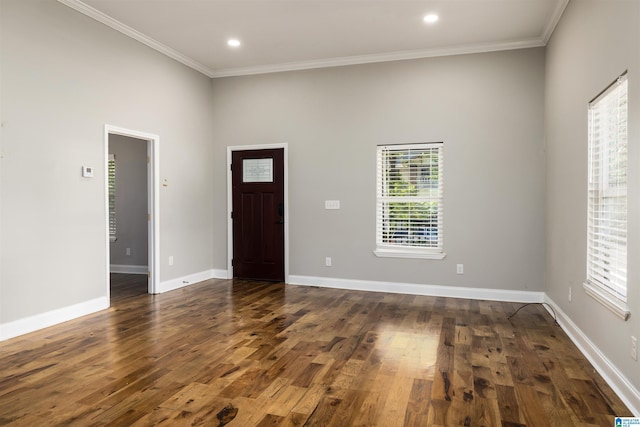 entrance foyer featuring crown molding and dark hardwood / wood-style flooring