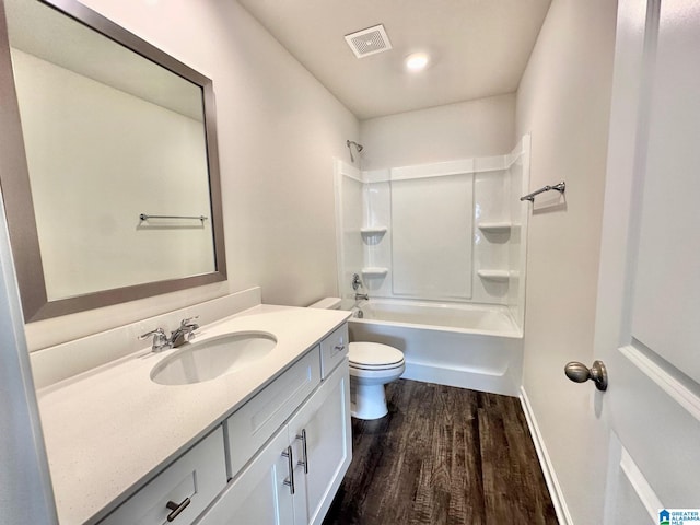 full bathroom with shower / tub combination, vanity, wood-type flooring, and toilet