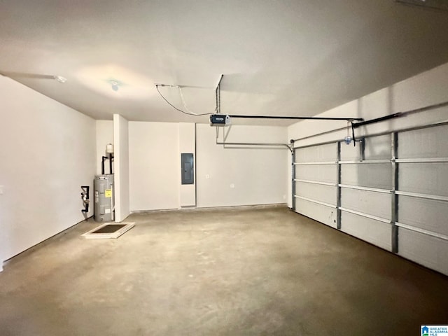 garage featuring electric panel, a garage door opener, and water heater