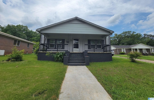 bungalow-style home featuring a front yard and covered porch