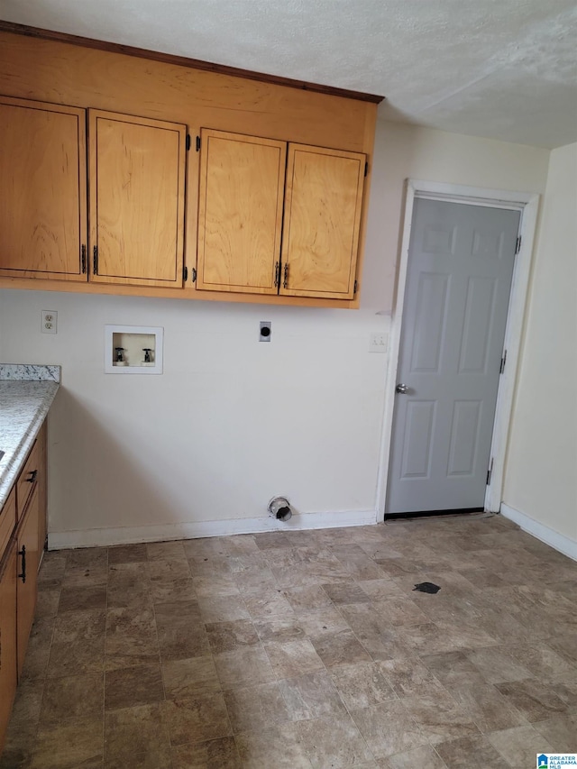 washroom with tile floors, washer hookup, electric dryer hookup, and cabinets