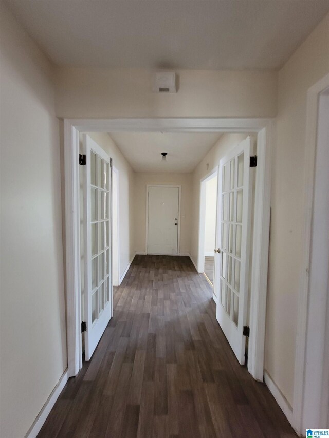 hallway with french doors and dark hardwood / wood-style floors