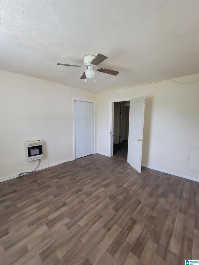 unfurnished bedroom featuring a textured ceiling, a closet, ceiling fan, and dark hardwood / wood-style floors