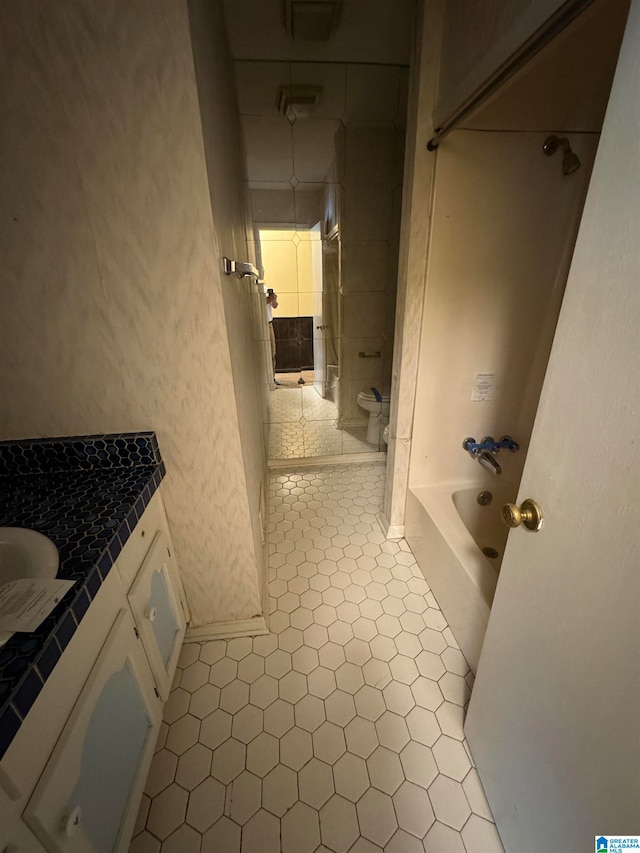 full bathroom featuring tile patterned flooring, vanity, toilet, and shower / bathtub combination