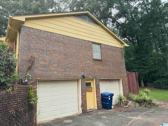 view of side of home featuring a garage