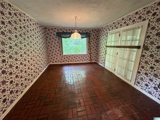 unfurnished dining area featuring a textured ceiling