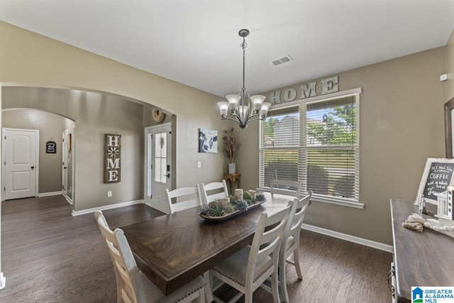 dining space featuring a chandelier and dark hardwood / wood-style floors