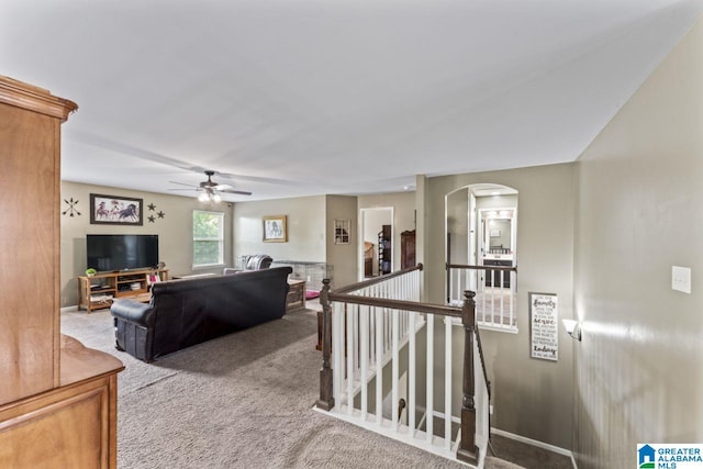 living room featuring carpet and ceiling fan