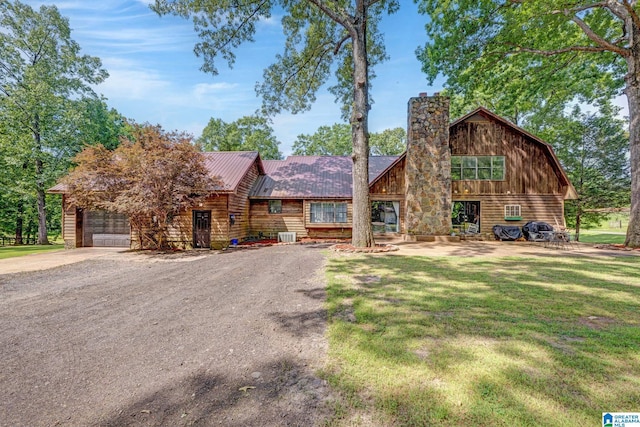 log cabin with a front yard