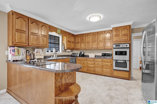 kitchen with sink, kitchen peninsula, appliances with stainless steel finishes, light tile patterned floors, and ornamental molding