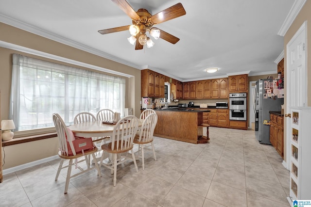 tiled dining room featuring a wealth of natural light, crown molding, and ceiling fan