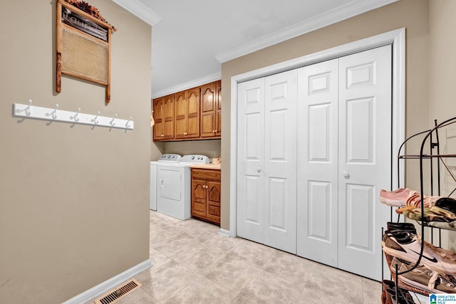 washroom featuring cabinets, washer and clothes dryer, ornamental molding, and light tile patterned flooring