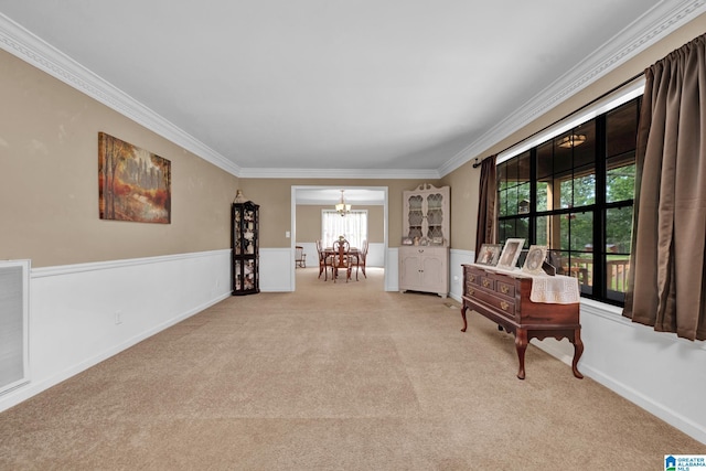 living area with light colored carpet, crown molding, and a chandelier