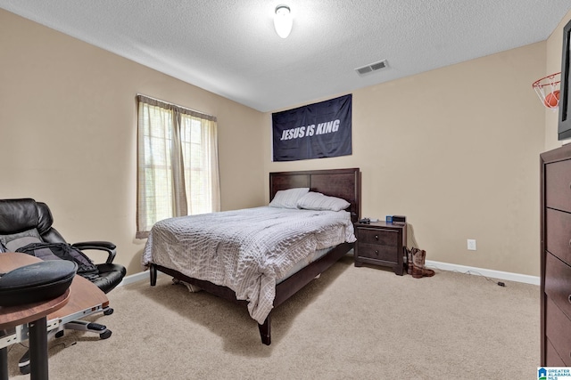 carpeted bedroom featuring a textured ceiling