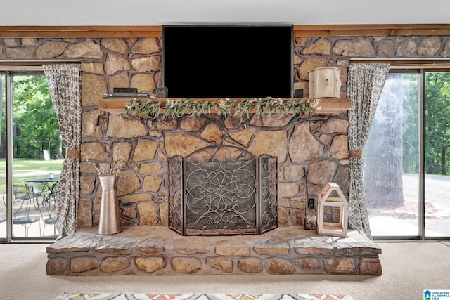 room details featuring carpet flooring and a fireplace