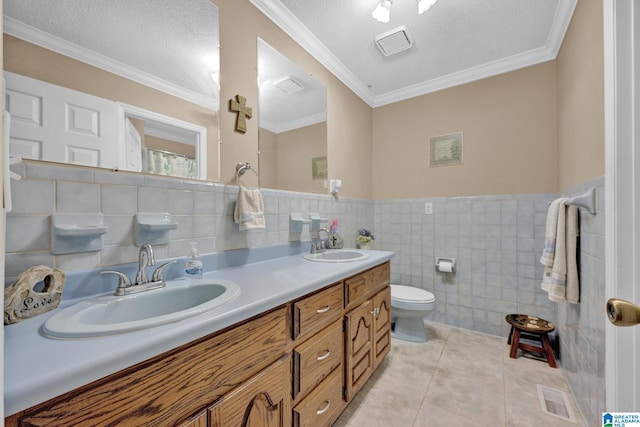 bathroom with a textured ceiling, tile patterned flooring, tile walls, and toilet