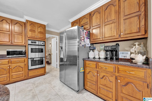 kitchen featuring appliances with stainless steel finishes, ornamental molding, and light tile patterned flooring