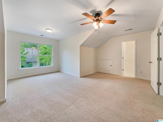 bonus room with light carpet, vaulted ceiling, and ceiling fan