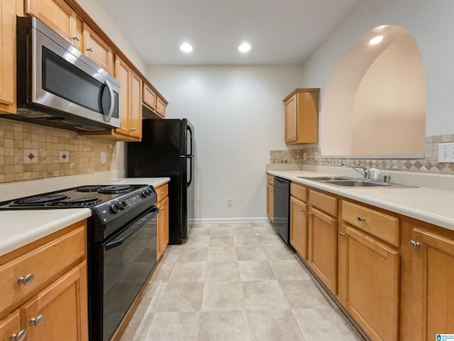 kitchen with sink, tasteful backsplash, and black appliances